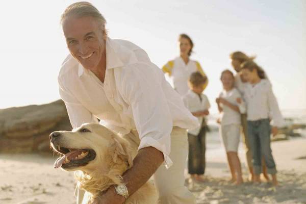 Family playing with their dog on the beach