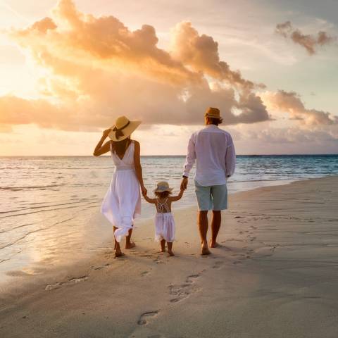 Family Enjoying Beach At Sunset