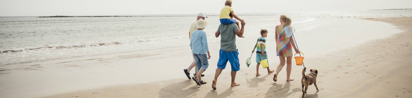 family on beach with a dog